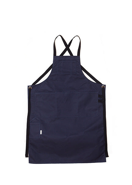  Navy canvas apron with multiple pockets and adjustable crossback straps, laid flat on a white background