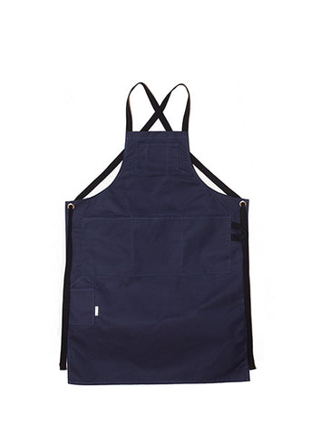  Navy canvas apron with multiple pockets and adjustable crossback straps, laid flat on a white background