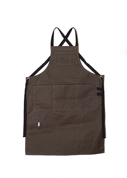 Pine canvas apron with multiple pockets and adjustable crossback straps, laid flat on a white background