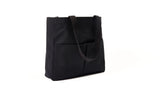 Black canvas Utility Carryall tote with two shoulder straps and front pockets, photographed on a white background
