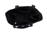 Top-down view inside an empty black canvas Utility Carryall tote, showing interior compartments and webbed handles
