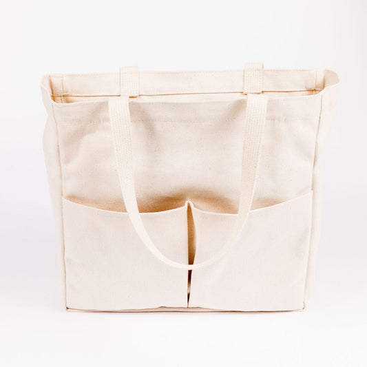 Natural canvas Utility Carryall tote with front pockets, shown against a white background