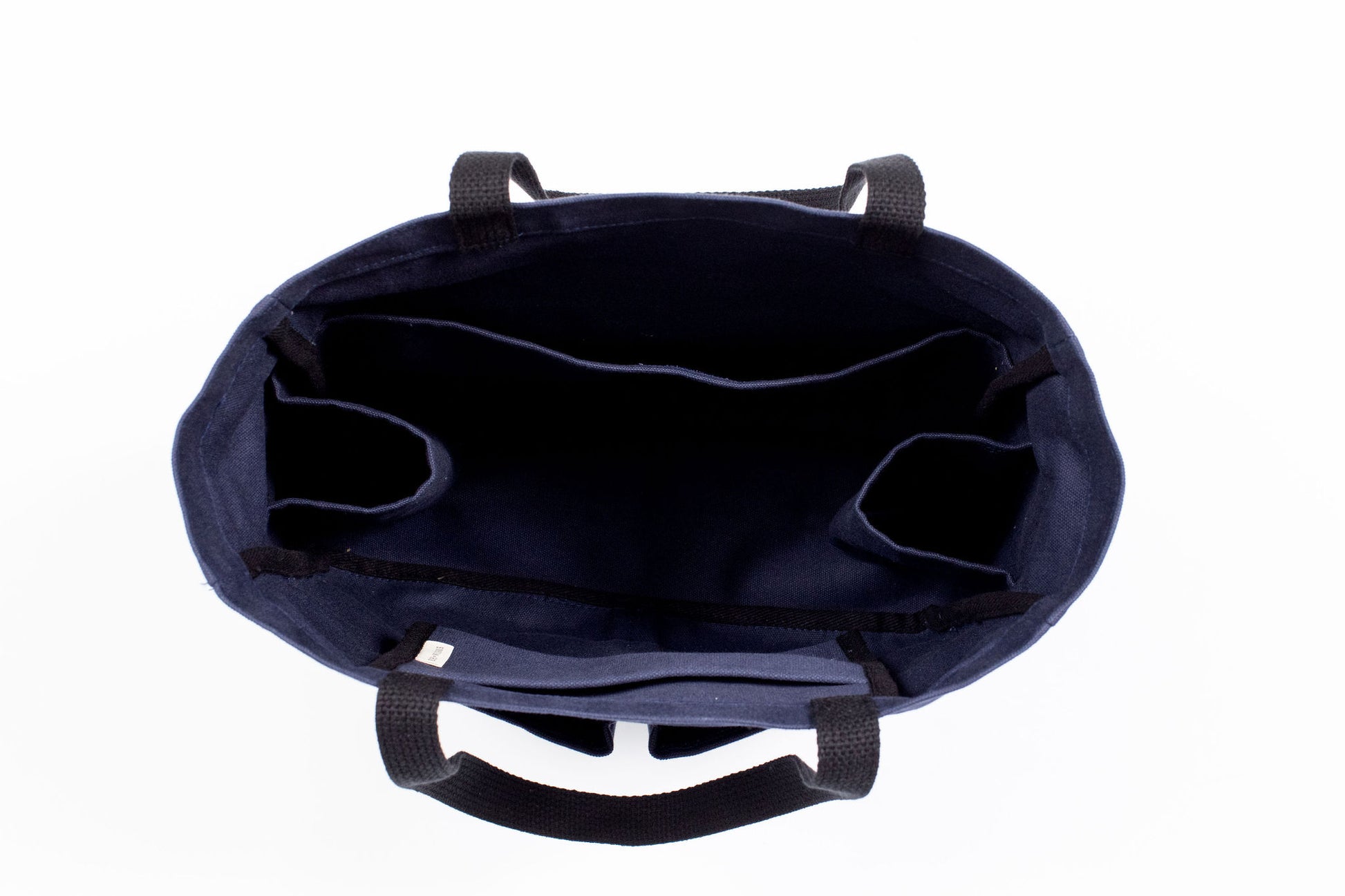 Canvas Utility Carryall tote in navy, viewed from above showing interior pockets and center divider