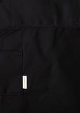 Close-up of a black canvas apron pocket with the EH·Works brand label