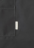 Close-up of a grey canvas apron pocket with the EH·Works brand label