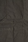 Close-up of pine canvas apron fabric showing pocket stitching and seams