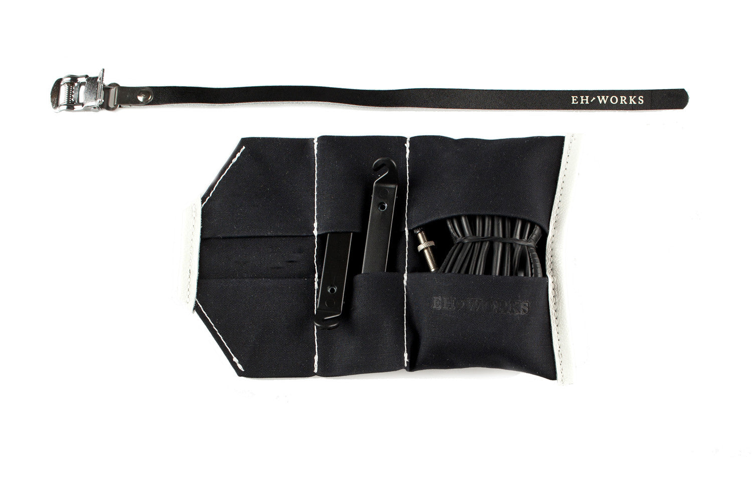  Open black canvas Sojourner tool roll with black leather trim, showing tire levers and a spare tube in the pockets