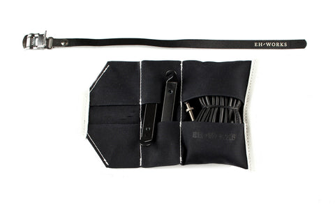  Open black canvas Sojourner tool roll with black leather trim, showing tire levers and a spare tube in the pockets