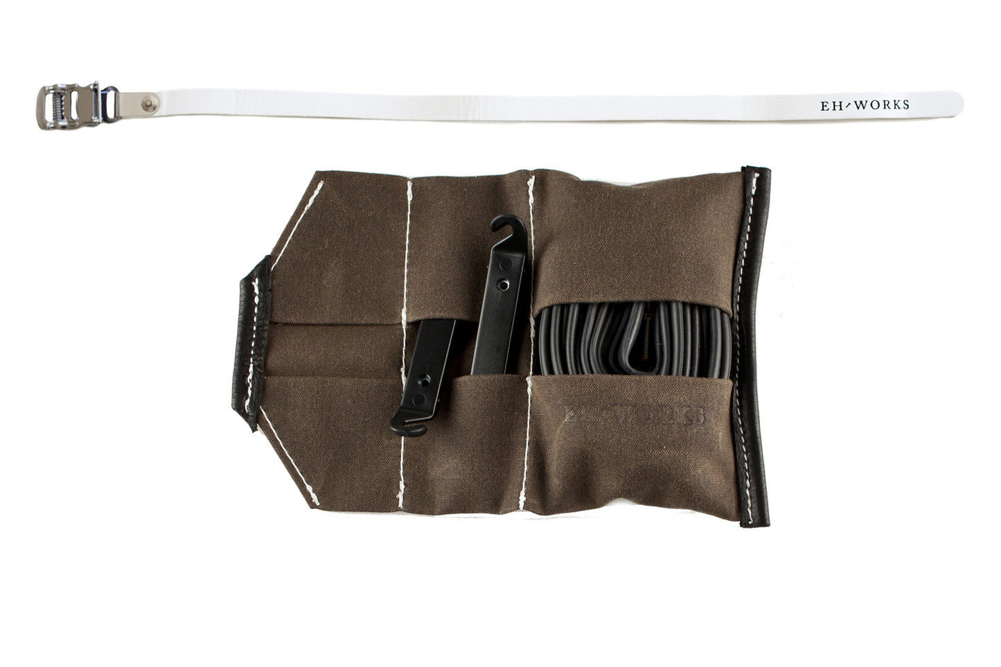  Open Sojourner tool roll in saddle brown canvas with white leather trim, showing tire levers and a spare tube in the pockets