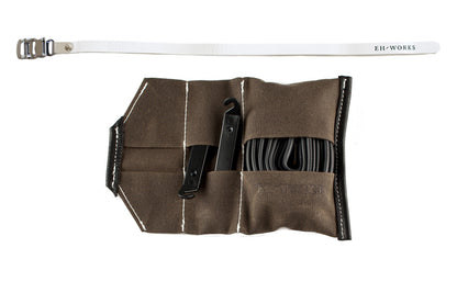  Open Sojourner tool roll in saddle brown canvas with white leather trim, showing tire levers and a spare tube in the pockets